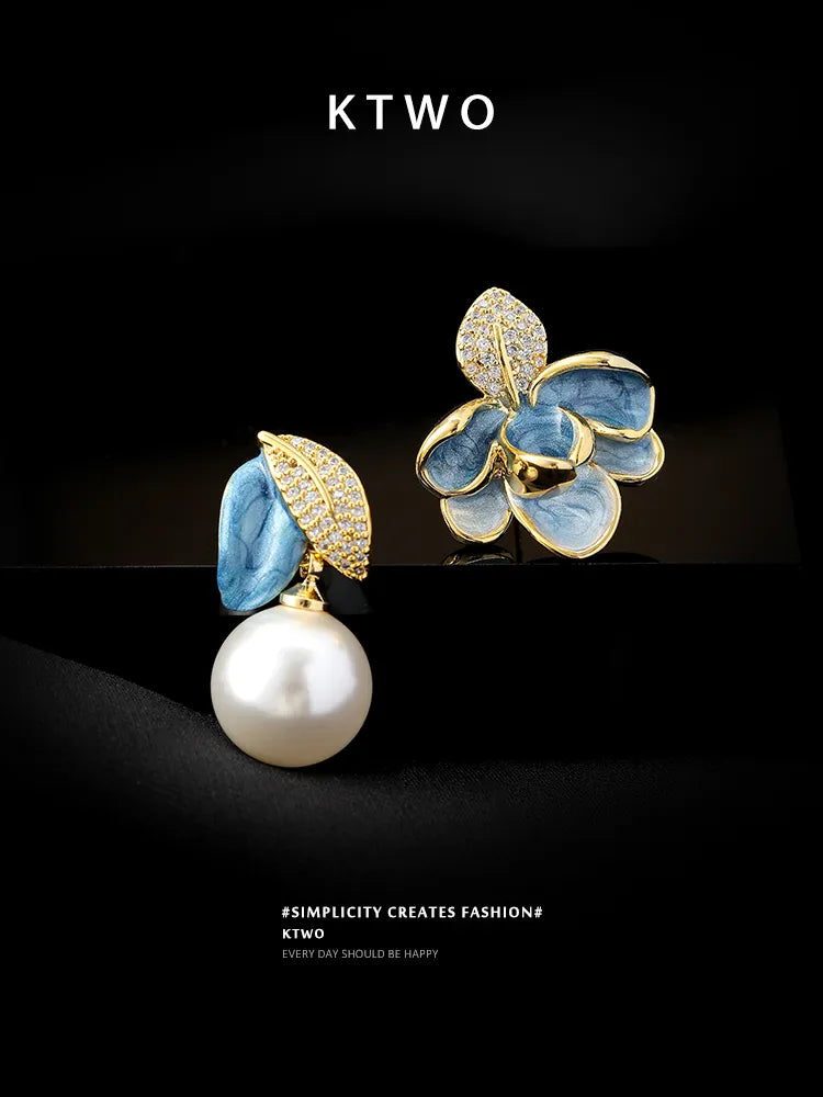 Lifestyle flatlay of asymmetric pearl earrings, a perfect unique gift idea for her.