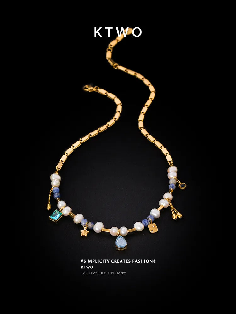 Close up of Blue Zircon Stone and Freshwater Pearl on Gold Pendant