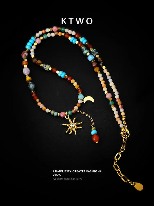 Bohemian sun and moon tassel necklace on a black background, showcasing the colorful gemstone beads and intricate pendant.