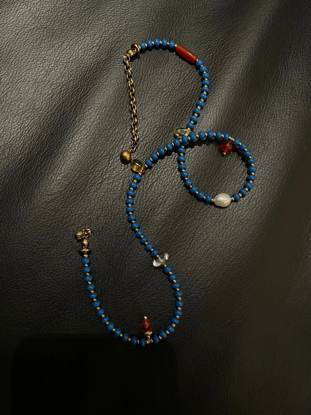 Extreme close-up of the handmade bead mix, featuring the luster of freshwater pearls, the raw texture of natural stones, and the smooth finish of imported glass beads.