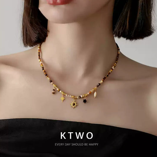 Woman wearing the tiger eye and Maillard stone bead necklace