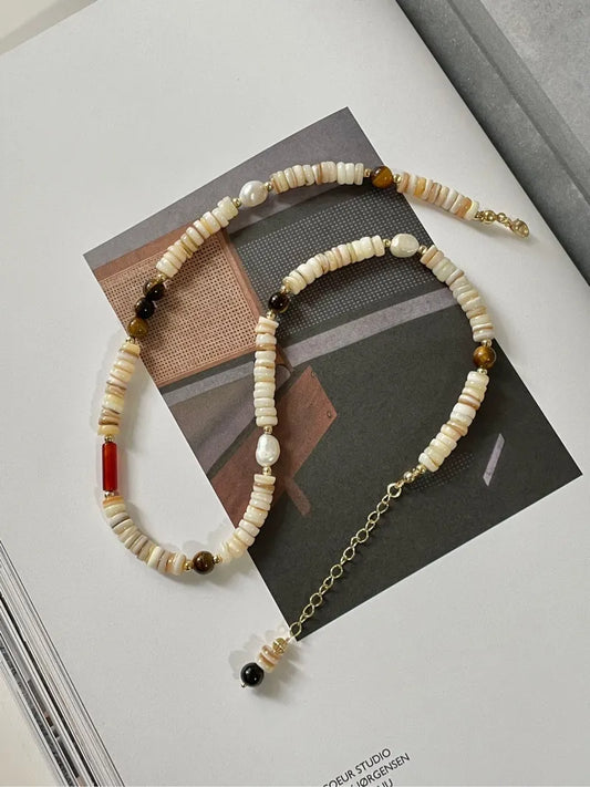 Close-up detail shot showing the unique texture and variation of each natural shell bead.