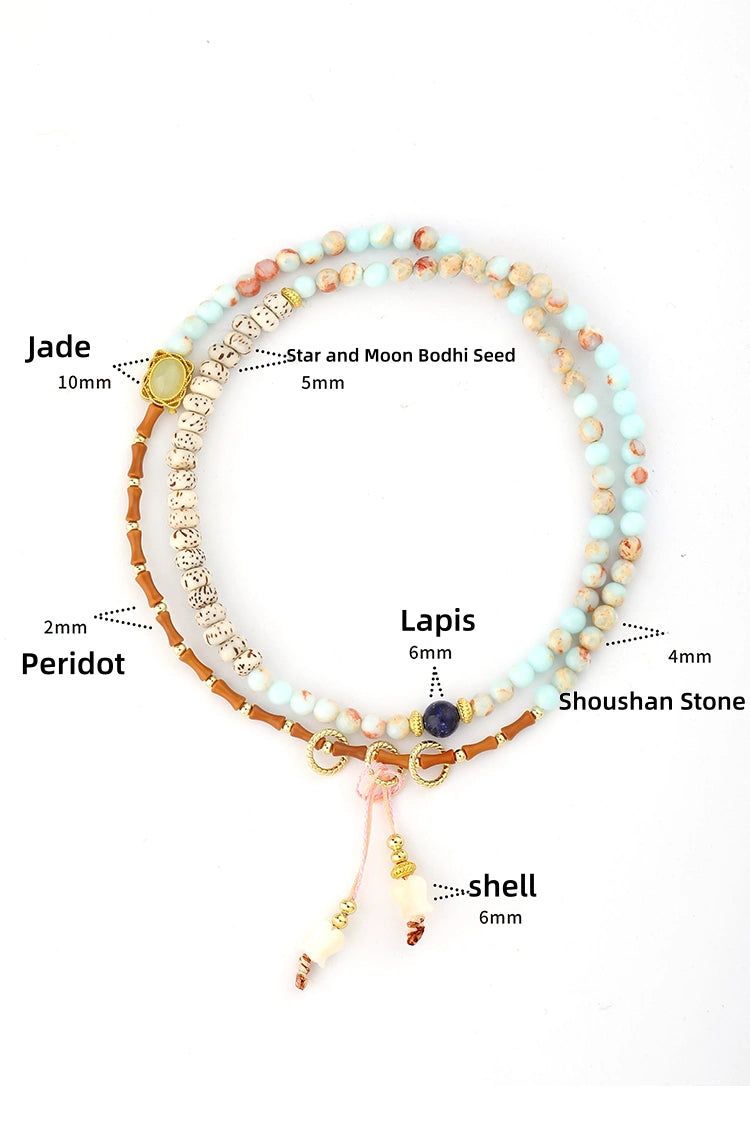 Close-up look at the materials used in our multi-wrap bracelet: featuring genuine Lapis Lazuli, Peridot gemstones, natural Bodhi Seeds, Jade, and a shell flower charm.