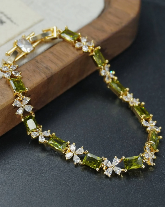 Close-up detail of the nature-inspired French bracelet, highlighting the olive green zircon