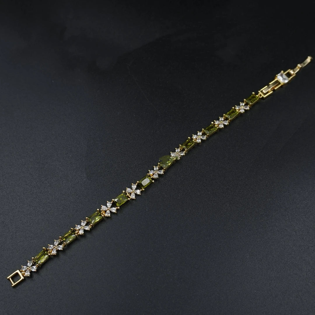 Flat lay view of the olive green bracelet , showing the sparkling zircon stone and gold-tone alloy clasp on a dark background.