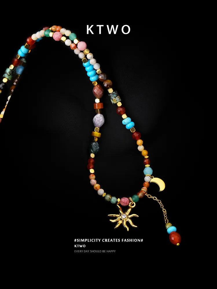 Flat lay of the boho chic necklace, featuring the sun and moon pendant with a long beaded tassel, perfect for gift ideas.