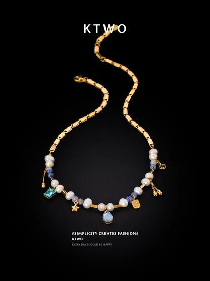 Close up of Blue Zircon Stone and Freshwater Pearl on Gold Pendant