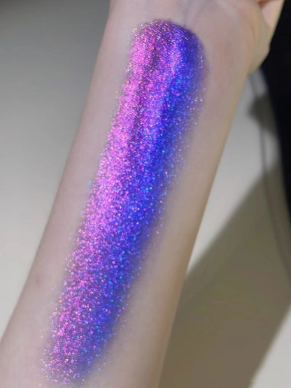 An arm swatch of our purple eyeshadow, showing the smooth, highly-pigmented application and the base color under direct light.