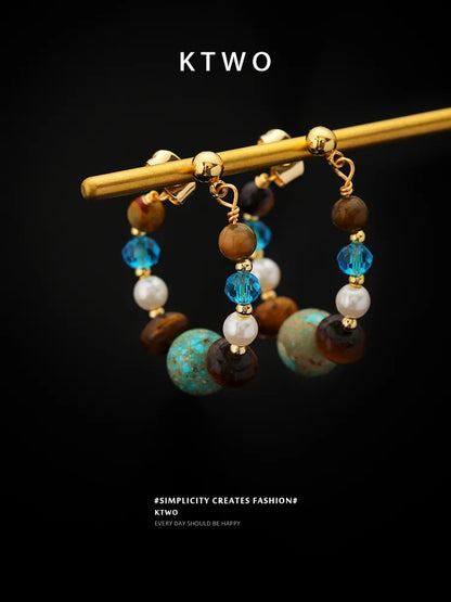 Close-up detail of the natural tiger eye and turquoise stones in these boho earrings.