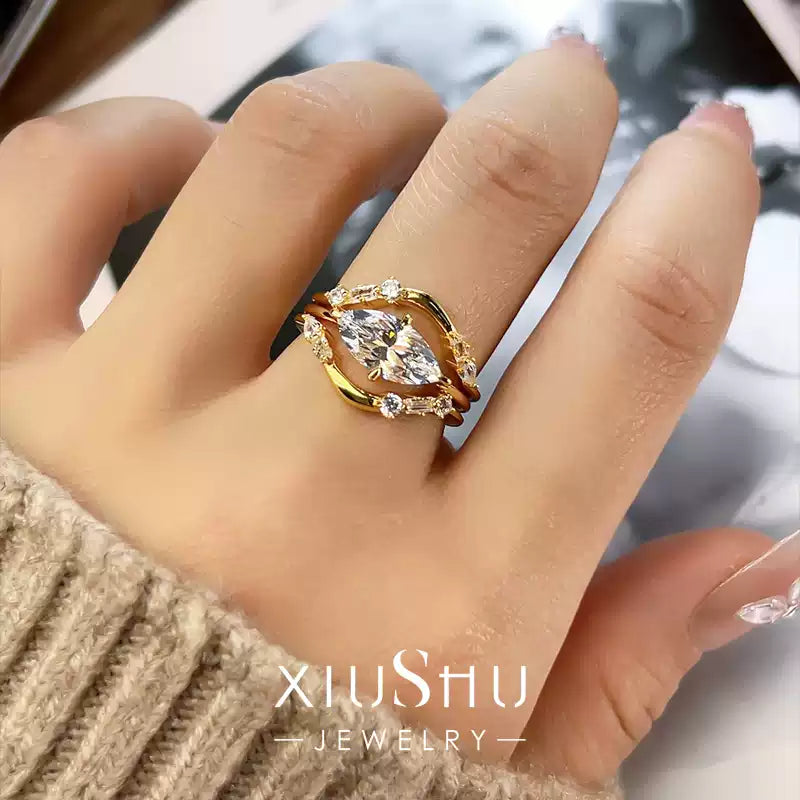 A woman's hand wearing the complete set of three stackable crystal rings, demonstrating the stylish layered look.