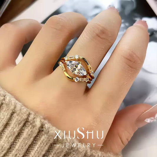 A woman's hand wearing the complete set of three stackable crystal rings, demonstrating the stylish layered look.