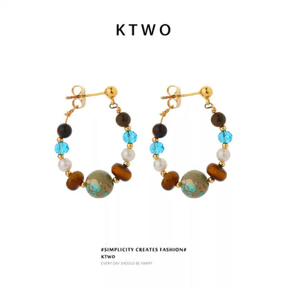 Vintage tiger eye and turquoise drop dangle earrings for women on a white background.