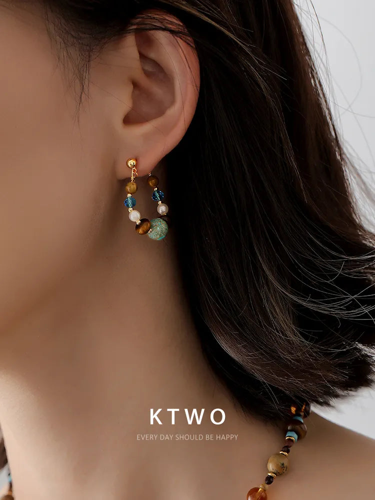 Close-up side profile of a woman modeling our boho chic turquoise and tiger eye earrings.